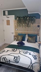 a bedroom with a large bed with a wooden headboard at The AppleTree in West Drayton