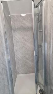 a shower with a glass door in a bathroom at The AppleTree in West Drayton