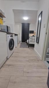 a laundry room with a washer and dryer on a floor at The AppleTree in West Drayton