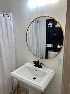 a bathroom with a white sink and a mirror at Modern 2 Bedroom Apartment in Monroeville