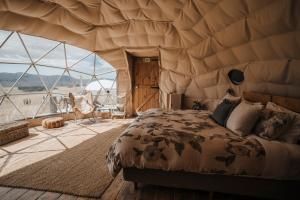 - une chambre avec un lit dans une tente dans l'établissement Valley Views Glamping, à Kurow
