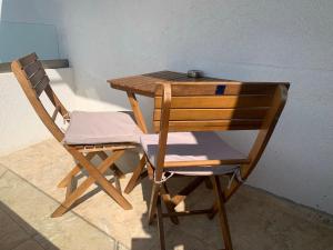 silla de madera, mesa de madera y escritorio en Apolonia Apartments, en Sozopol