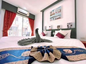 Postel nebo postele na pokoji v ubytování Hotel Baya Phuket