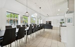 a dining room with a long table and chairs at Pet Friendly Home In Ulfborg in Ulfborg
