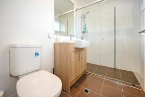 a bathroom with a toilet and a sink and a shower at Lovely Beach House -Amazing Location, Pets - ZB9 in Buddina +24 photos