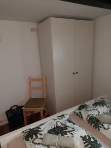 a bedroom with a bed and a chair and a cabinet at Auszeit in Mölln