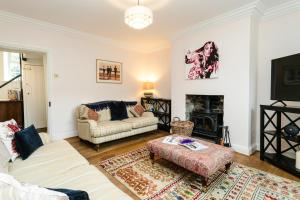 a living room with a couch and a fireplace at Westhill House in Warkworth