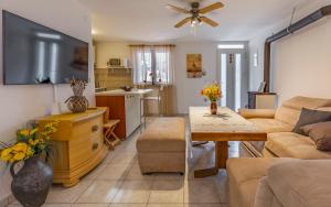 a living room with a couch and a table at Villa Iness Medulin in Medulin