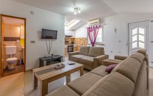a living room with a couch and a table at Villa Iness Medulin in Medulin +16 photos