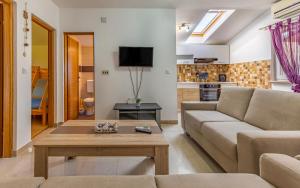 a living room with a couch and a coffee table at Villa Iness Medulin in Medulin