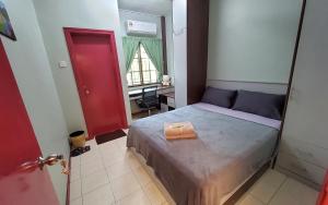 a bedroom with a bed and a red door at Putrajaya Transit Romestay in Putrajaya