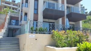 an apartment building with stairs and a balcony at Anthic 7 Apartment 3 in Sozopol