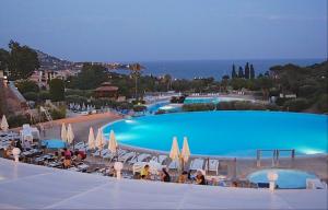 a view of a large swimming pool with umbrellas at Vacances en paradis in Agay - Saint Raphael