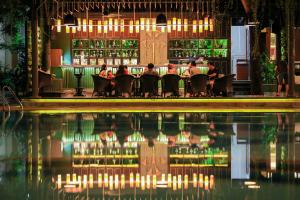 a group of people sitting at a bar at Borei Angkor Resort & Spa in Siem Reap