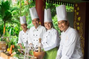 a group of chefs posing for a picture in chefs hats at Borei Angkor Resort & Spa in Siem Reap