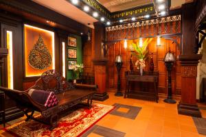 a living room with a couch and a table and a fireplace at Borei Angkor Resort & Spa in Siem Reap