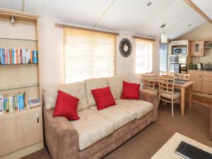 a living room with a couch with two red pillows at Stanley's Sanctuary in Cockermouth