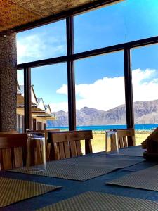 a dining room with a table and a view of the ocean at Mentsel Merak Pangong in Kakstet
