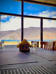 a room with a large window with a view of the mountains at Mentsel Merak Pangong in Kakstet