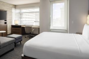 a hotel room with a bed and a desk and a bed and a window at Residence Inn by Marriott Oakland Downtown in Oakland