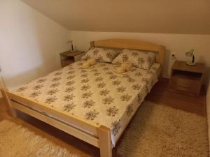 a bedroom with a bed with two teddy bears on it at Apartman Saša in Vranje