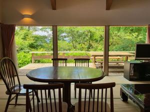 mesa y sillas en una habitación con ventana en Kiyo's Gokokuen "Tatsumado" - Vacation STAY 06870v en Kasama