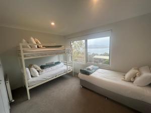 a bedroom with two bunk beds and a window at House Matterhorn in Jindabyne