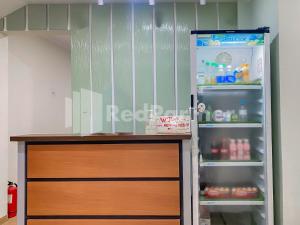 Mamifokobo Guesthouse Puncak Mitra RedDoorz في Ciloto: ثلاجة بابها مفتوح في الغرفة