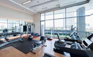 a gym with treadmills and cardio equipment in a building at Citiresort @sea sriracha in Si Racha