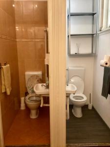 a bathroom with two toilets and a sink at Central Apartments of Budapest in Budapest
