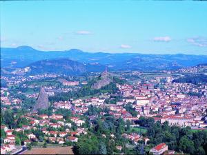 an aerial view of a city with buildings and mountains at Deltour Hotel Le Puy En Velay in Le Puy-en-Velay