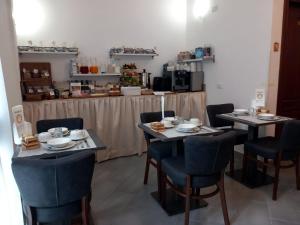 a restaurant with two tables and chairs and a counter at camere Caterina in Bonassola