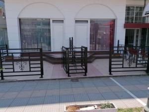 a group of benches in front of a building at Adonis Apartments in Paralia Katerinis