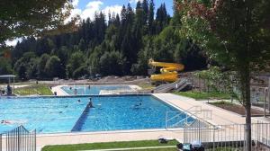 a large swimming pool with people in the water at Haus Wander-Lust in Lauterbach