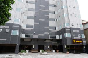 a tall gray building with a hotel sign on it at F Hotel Jian in Jian