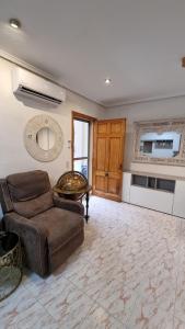a living room with a couch and a table at Bali Beach Puzol relax en la playa cerca de Sagunto y Valencia in Puzol