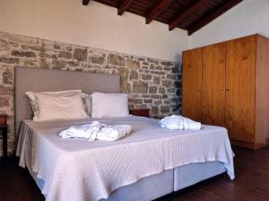 a bedroom with a bed with two towels on it at Thalassa Apartments in Rethymno