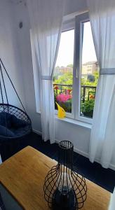a room with a table and a window with a view at 33 Coquette Apartment in Baia Mare