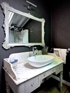 a bathroom with a sink and a mirror at La Via di Leonardo in Sesto Calende