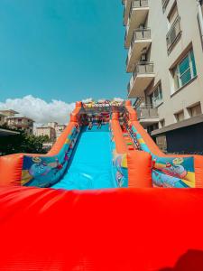a large inflatable water slide in front of a building at Brora Family Village in Lido di Savio