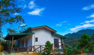 una casa en las montañas con un cielo azul en Maridian Hotel en Ella