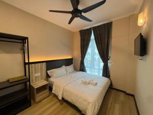 a bedroom with a bed with a ceiling fan at Dey Hotel Kota Bharu in Kota Bharu +4 photos