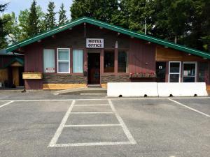 a building with a sign that reads winter coffee at Copper River Motel in Terrace