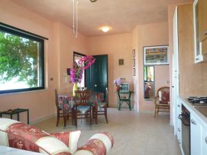 a living room with a couch and a table at Villa Panthea in Capo Vaticano