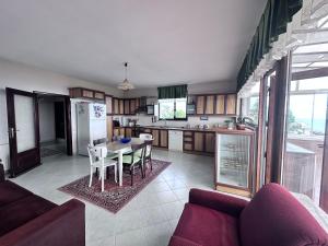 a kitchen and dining room with a table and chairs at Beautiful Villa near the airport & city in Trabzon