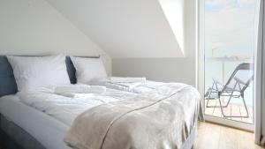Posteľ alebo postele v izbe v ubytovaní Apartamenty Sun & Snow Posesja Kapitańska