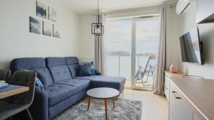Televízia a/alebo spoločenská miestnosť v ubytovaní Apartamenty Sun & Snow Posesja Kapitańska