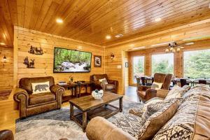 a living room with a couch and chairs and a tv at NEW! Panorama Mountain View! PET Friendly and GameRoom with Pool Table, Hot Tub, Fireplace and King Bedrooms with Jacuzzi in Sevierville