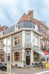 a large building on a city street at Le Cerf Vert in Dinant