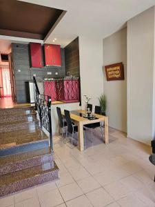 a dining room with a table and some chairs at Adonis Apartments in Paralia Katerinis